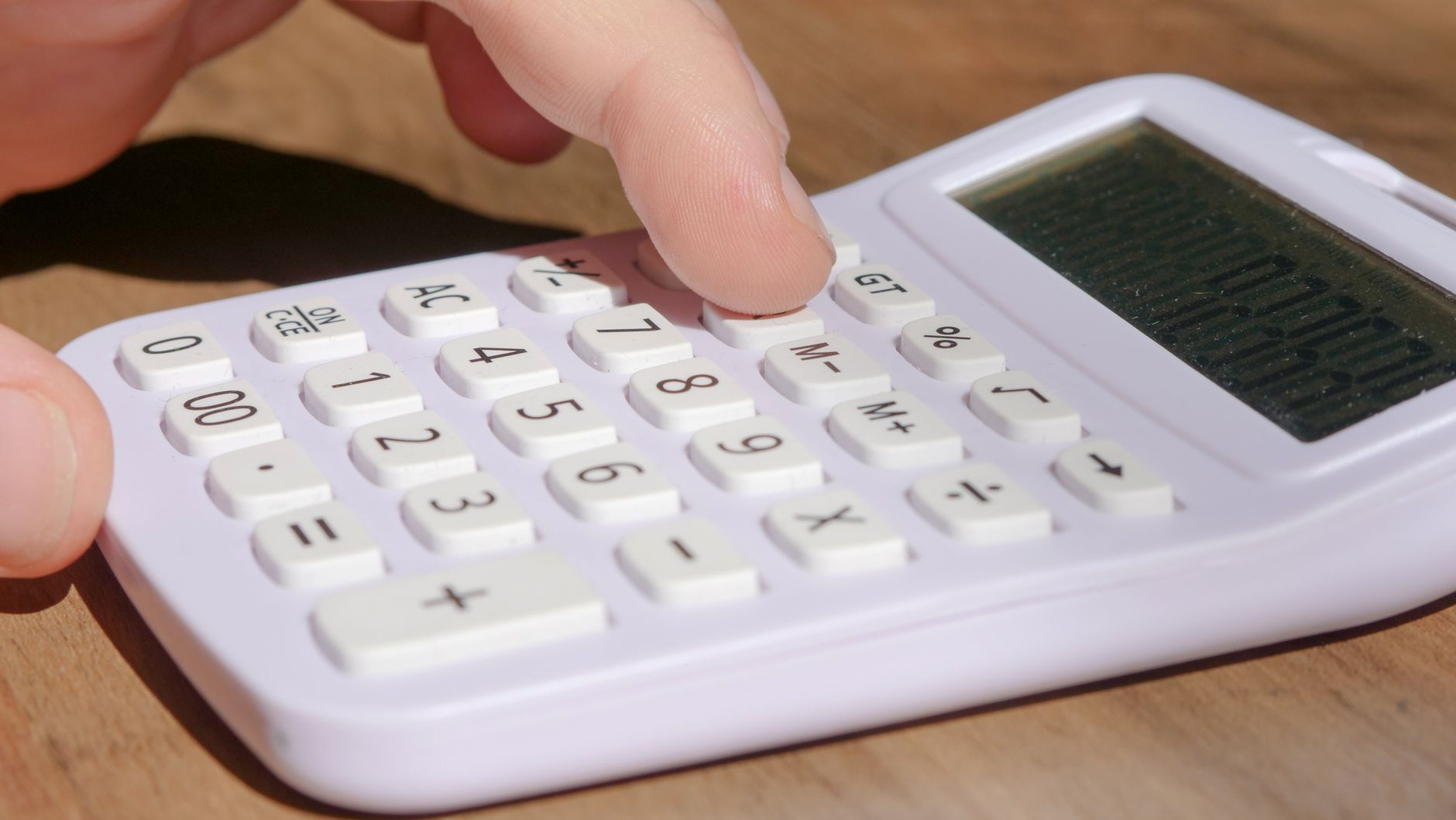 Hand using a calculator
